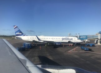 photo of jetblue plane sitting at an airport; you can earn the airline's miles via many partners
