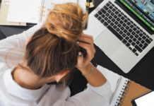 Bad News! U.S. Bank Altitude Reserve Changes Coming in December a woman sitting at a desk with a laptop and notebook