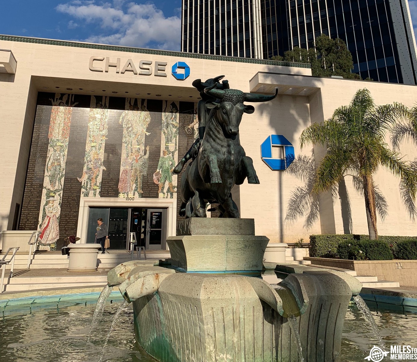 a statue of a bull in front of a bank building