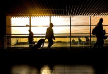 The Ultimate Travel Hack – Follow the Golden Rule and Be Fulfilled a silhouette of a man with luggage in an airport