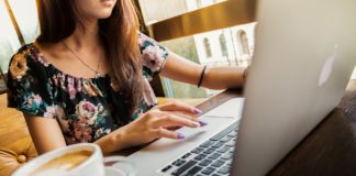 Earn Up to 2,500 Bonus Miles with Three Airlines Shopping Portals a woman sitting at a table with a laptop