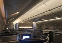 Booking a United Polaris Transcontinental Seat for Cheap! an airplane with seats and a television