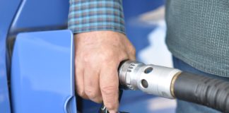 Gas Discount for Amazon Prime Members, Save 20 Cents/Gallon Every Friday Through May 29 a hand holding a gas pump