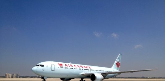 a white airplane on a runway