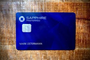 a blue credit card on a wooden surface