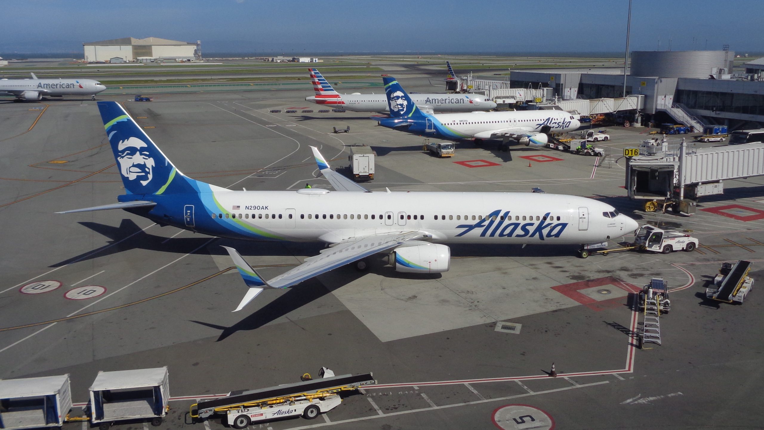 a group of airplanes parked at an airport