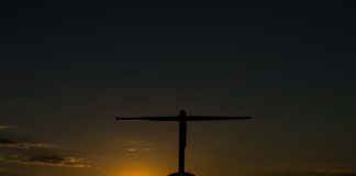 Lesson Learned – I’ll Now Do This on Every Premium Class Award Booking a silhouette of an airplane at sunset