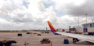 Book Holiday Travel Now! Latest Southwest Schedule Extension Details an airplane wing on a runway