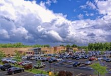 Excellent Citi Offer For Up To 10% Off Walmart a parking lot with cars and trees in front of a building