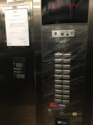Plastic wrap over the elevator buttons