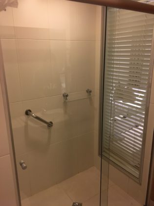 Hilton Garden Inn Shower has window and blinds