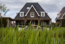 Our Biggest Travel Expense Is Back Home a grass in front of a house