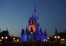 Get $400 Bonus & $100 Referrals with Chase Disney Card a castle with a clock at night