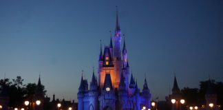 Get $400 Bonus & $100 Referrals with Chase Disney Card a castle with a clock at night