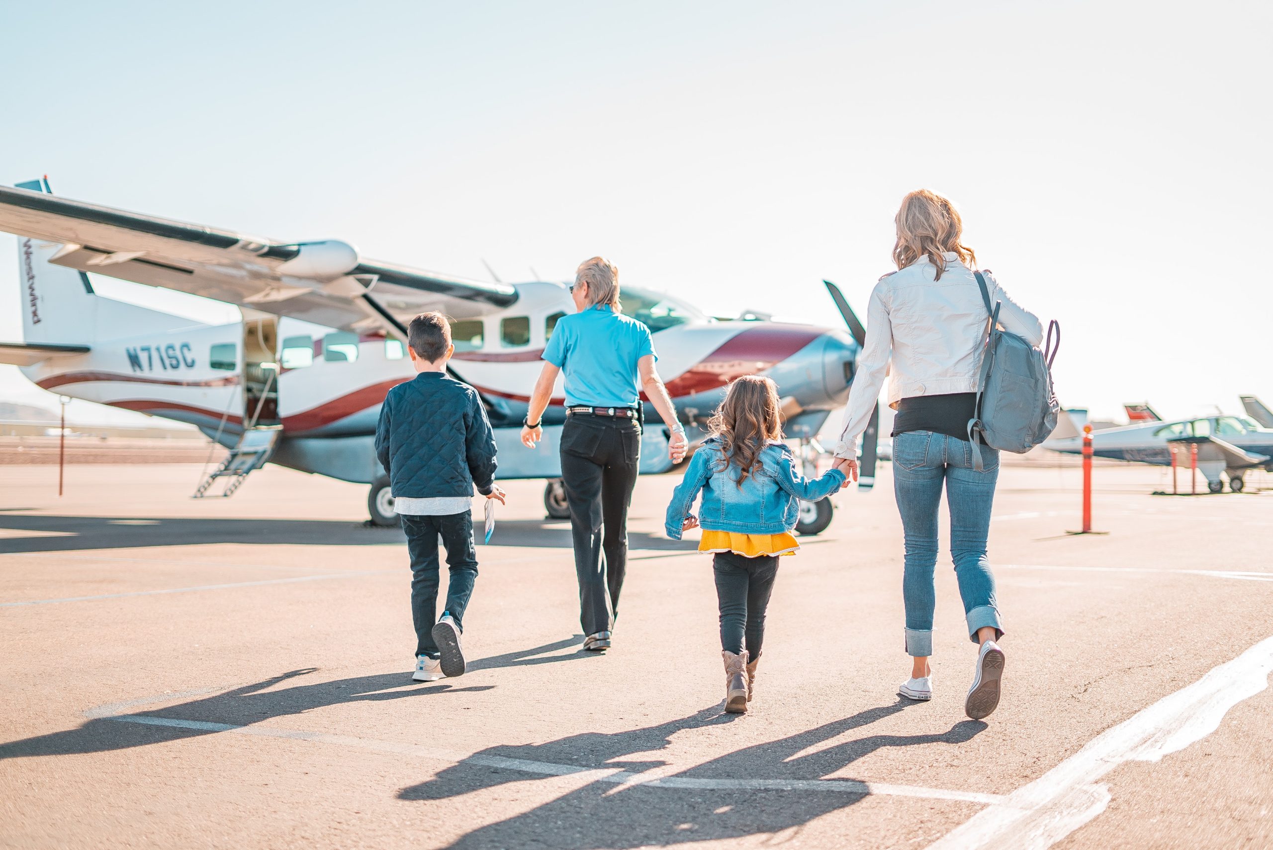 a group of people walking towards an airplane