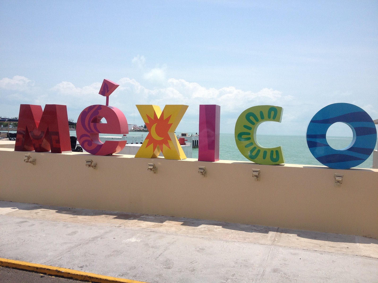 Image of sign saying "Mexico" along a beach