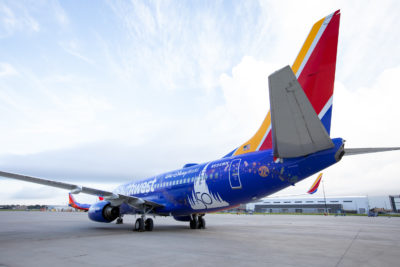 a blue airplane with a red and yellow tail