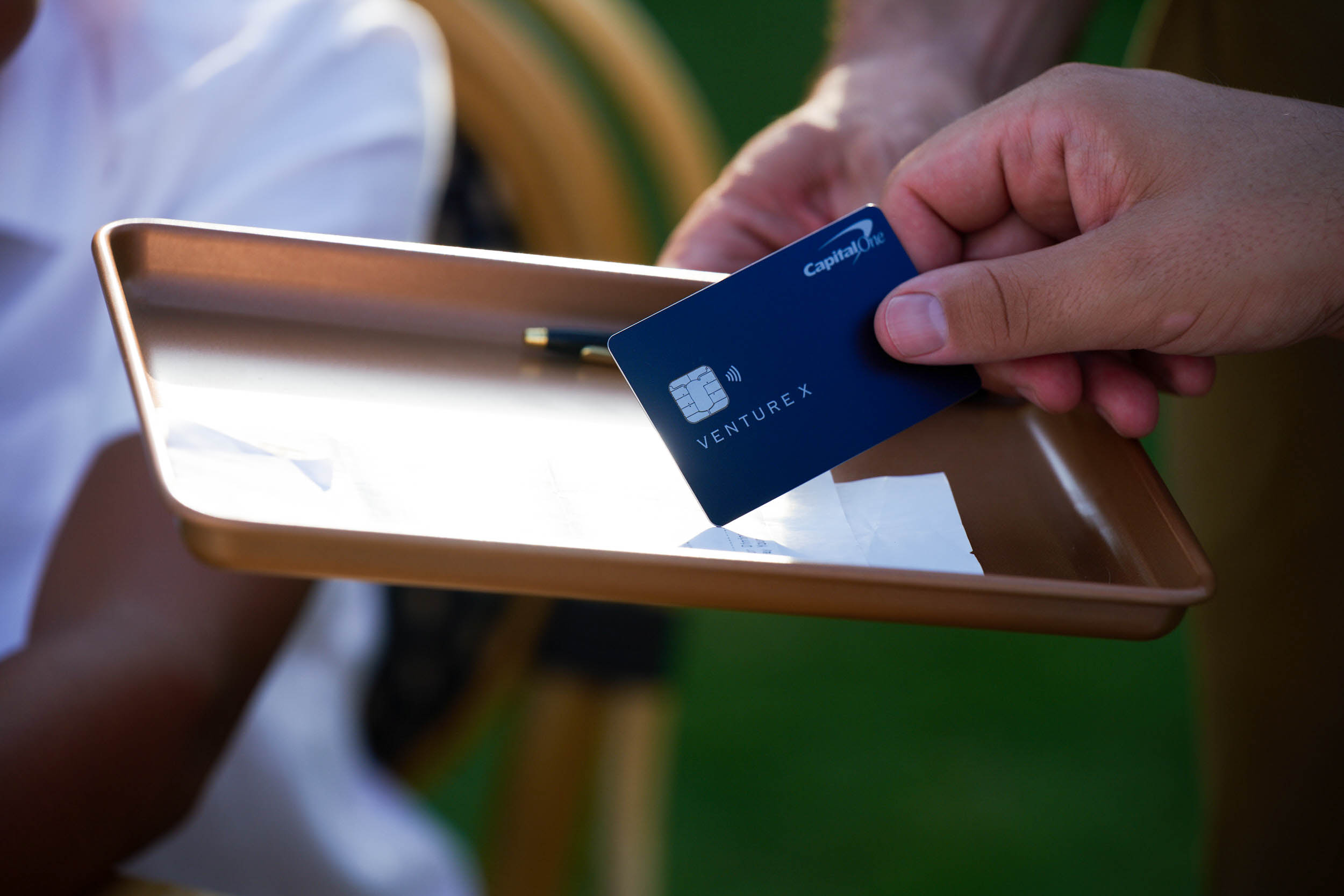 Image of hand holding Capital One credit card