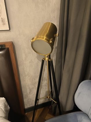 Image of lamp on tripod in guest room