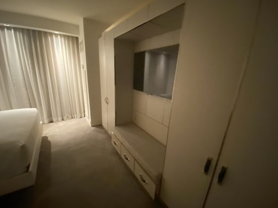 Image of TV and closed closet in the hotel room