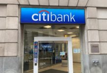 100K Online Bonus for Citi Strata Elite Card a glass door of a bank