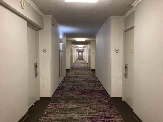 Image of carpeted hallway leading to guest rooms