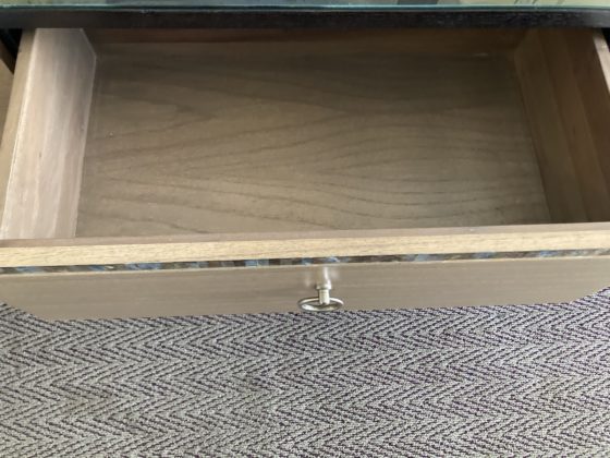 An open drawer in a wooden dresser