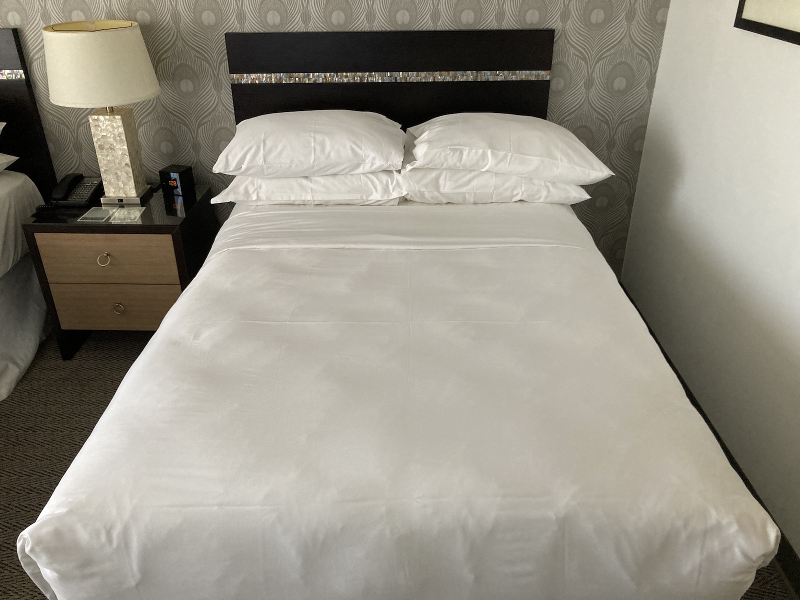 Picture of a hotel bed with pillows on it