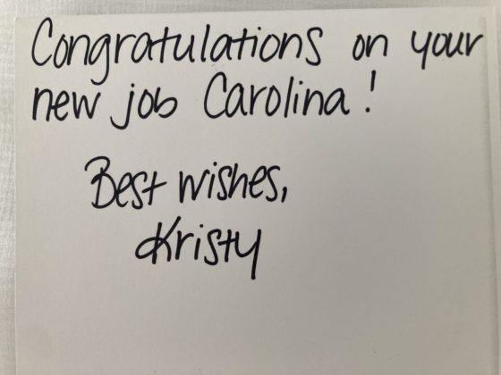 Photo of a handwritten note saying "Congratulations on your new job Carolina! Best wishes, Kristy"
