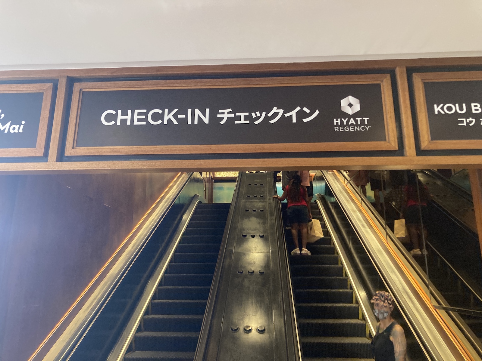 Photo of escalator going up and sign toward the check-in area