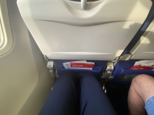 Photo of legroom on Southwest Boeing 737-700; knees are up against the seat in front during flight as unaccompanied minor