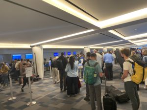 Photo of people standing in long lines at the Palm Springs airport check-in area