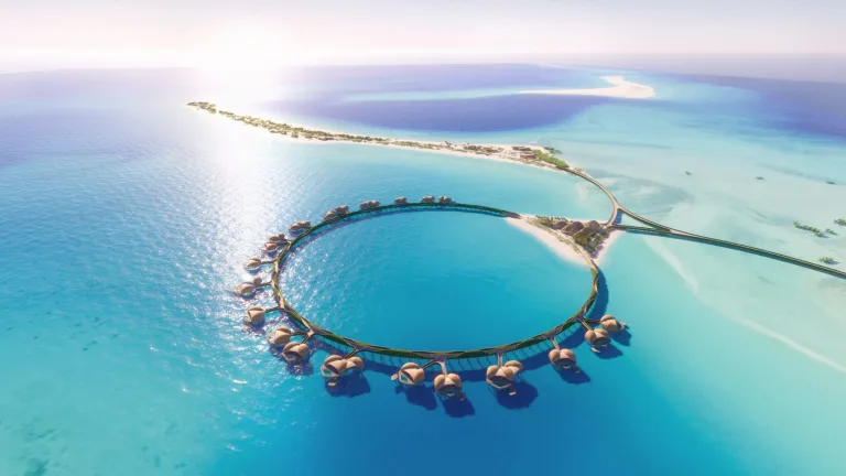 a bridge over water with huts and a bridge over the water