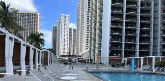 Marriott Bonvoy Boundless Card Offering 3 Free Nights and 50,000 Points a pool with chairs and a building in the background