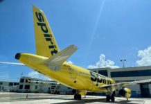 New Benefit: Get Two Free Checked Bags with Spirit Airlines Card a yellow airplane on the tarmac