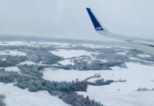 Canceled Flights & Incredible Memories: Taking Our Family of 6 to Scandinavia on Points & Miles: A Full Breakdown & How We Recovered an airplane wing over a snowy landscape