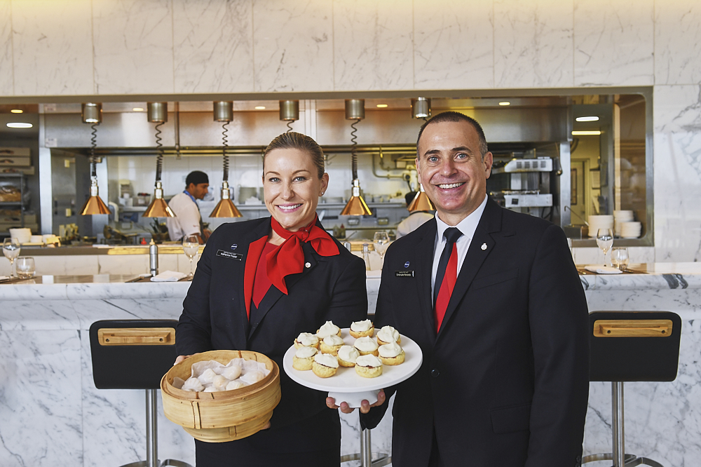 a man and woman holding a plate of food