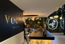 voco Strasbourg Review: A Garden Oasis in a Gorgeous City a hotel lobby with a bar counter and a sign