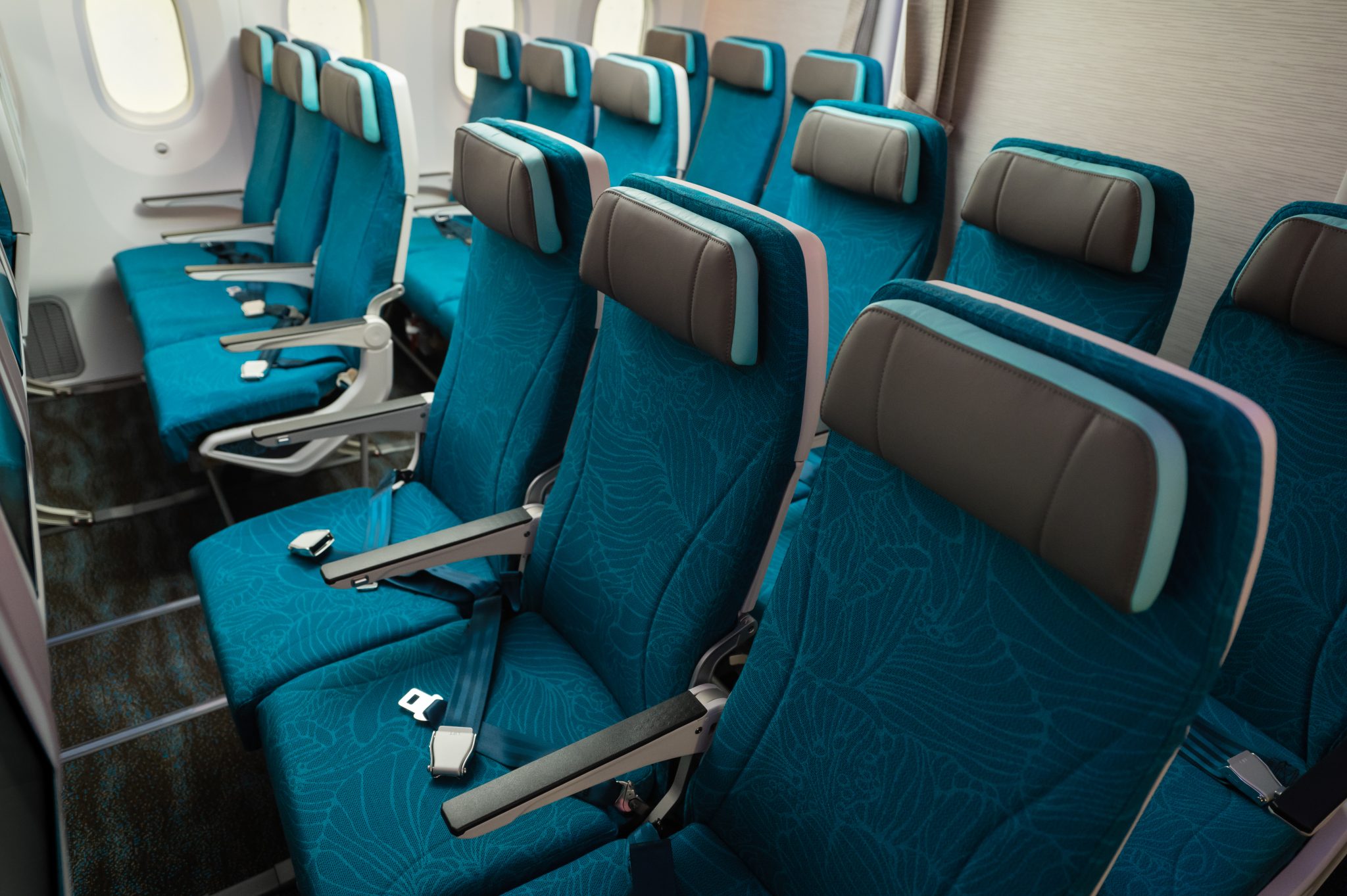 a row of blue seats in an airplane