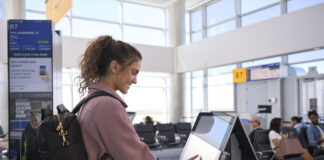 (Now In Effect) United Making Big Changes to MileagePlus Program Prioritizing Cardholders a woman using a touch screen