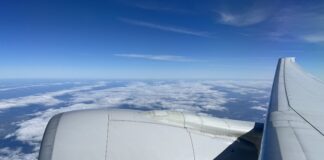 United Airlines Mile Play Promotion: Earn Bonus Miles for Flights Through March 9 a plane wing with clouds in the background