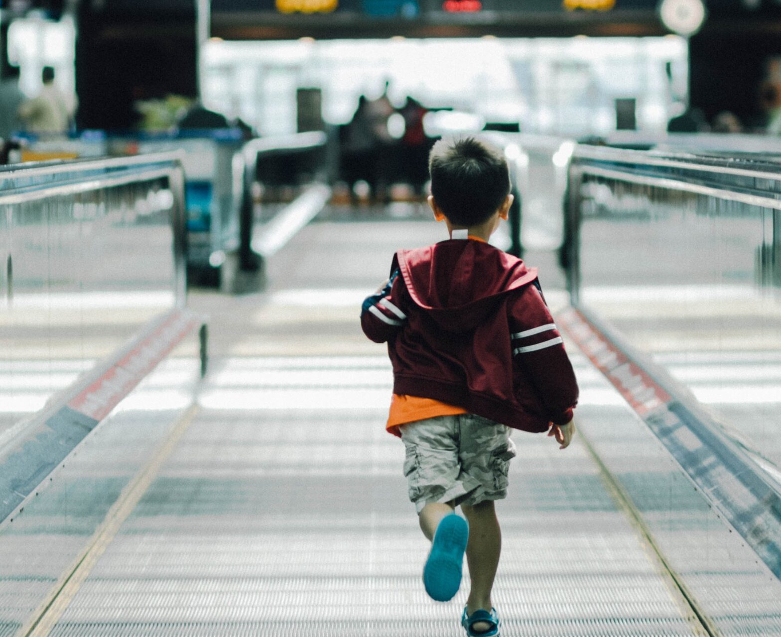 a child running on an escalator