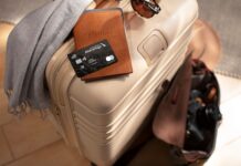 Earn 100,000 Bonus Miles with Citi / AAdvantage Executive World Elite Mastercard a luggage with a credit card and sunglasses