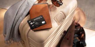 Earn 100,000 Bonus Miles with Citi / AAdvantage Executive World Elite Mastercard a luggage with a credit card and sunglasses