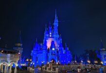 My Insane Walt Disney World Trip Strategy & How I Saved Thousands Thanks to Miles & Points! a castle with blue lights at night