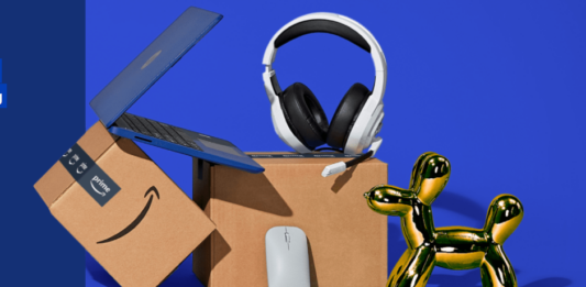 a box with a laptop and headphones and a balloon dog