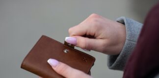 Mesa Adds Omni Hotels & Resorts As Second Hotel Partner a person holding a wallet