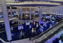(Dead) New Status Match Opportunity at Fontainebleau Las Vegas: Get $300 Credit & More! a large casino with escalators and slot machines