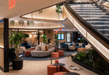 Check Out the New Chase Sapphire Lounge by The Club at LaGuardia Airport a large lobby with a staircase and a large couch