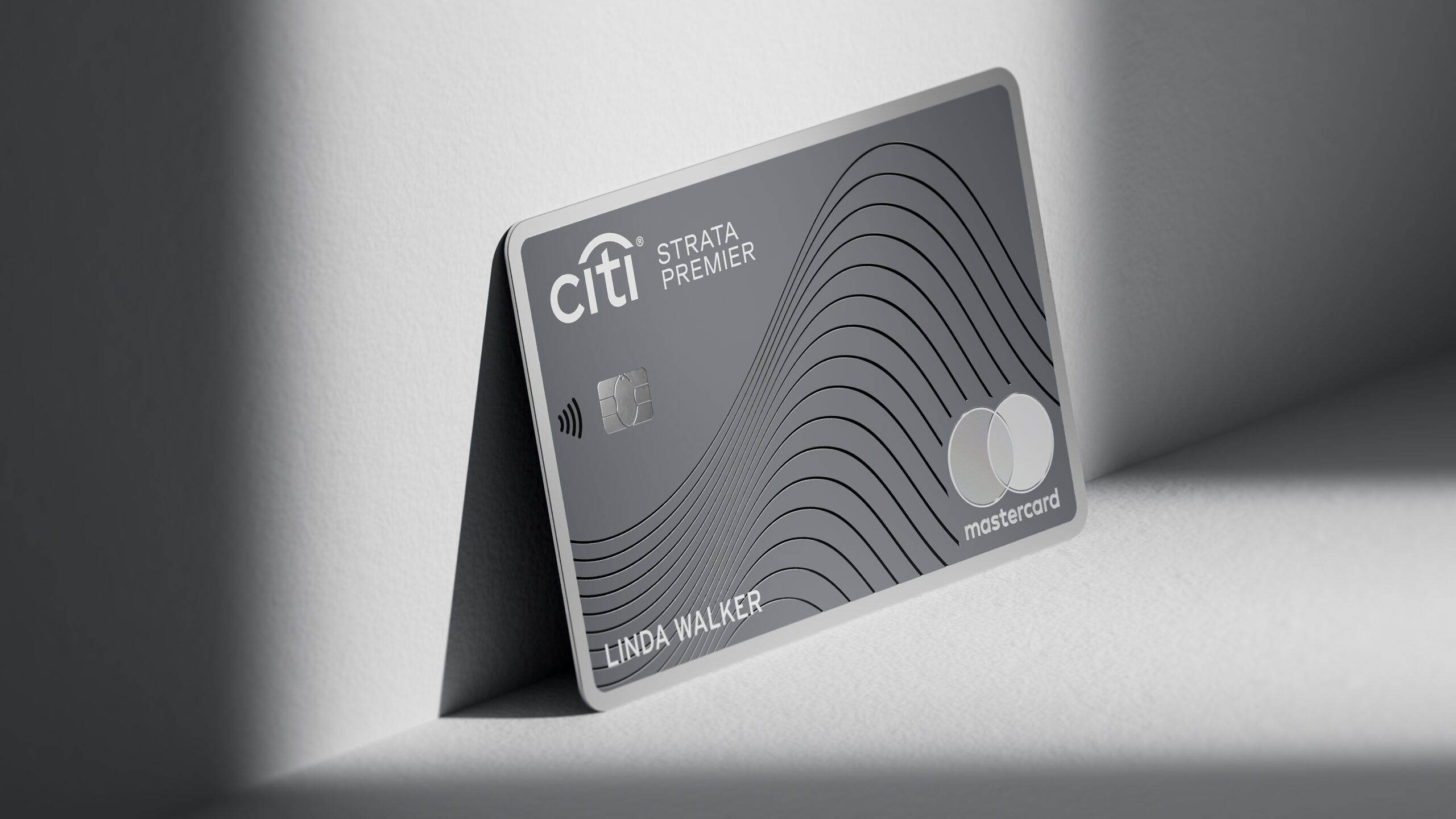 a grey credit card on a white surface